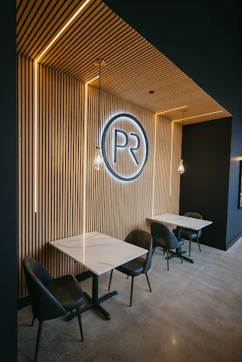 Plymouth Roast illuminated PR wordmark wall