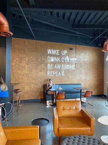 Royal Oak Roast brand wall reading Wake Up Drink Coffee Be Awesome Repeat